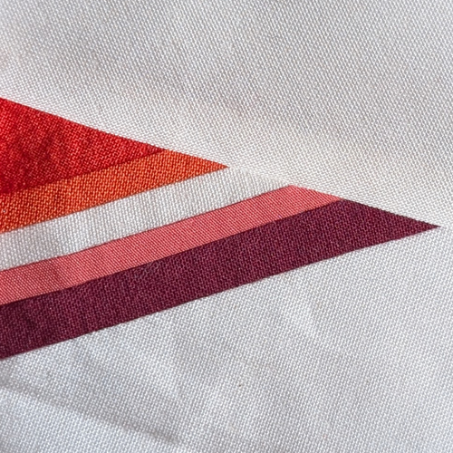 Lesbian Flag FPP quilt block pattern laid out with vibrant fabric strips